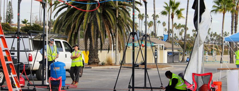 A field crew uses a custom-built rainfall generator to create controlled wet-weather conditions in a Long Beach parking lot – part of an effort to quantify street sweeping’s effectiveness in preventing roadway pollution from entering storm drains. Researchers are leveraging the study to also investigate street sweeping’s ability to remove microplastics.