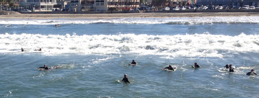 Surfers paddle away from shore at San Diego’s Ocean Beach shortly after a storm. SCCWRP and its partners have completed a study establishing the threshold at which levels of the HF183 fecal marker in wet-weather runoff correspond to an elevated illness risk for people swimming in contaminated receiving waters.