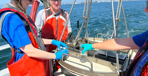 A crew places sediment collected from the seafloor into jars during field sampling for the Sediment
Quality element of the Southern California Bight 2023 Regional Monitoring Program. More than 20
field crews collected more than 340 sediment grab samples across more than 1,500 square miles of
coastal water in the Southern California Bight.