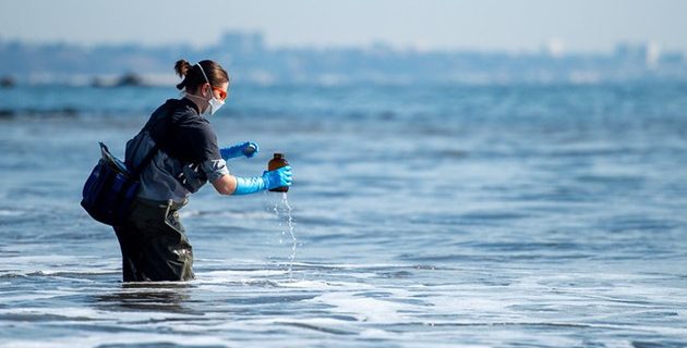 A field crew member from Heal the Bay collects a water sample from Santa Monica Bay as part of an ongoing, multi-agency water-quality monitoring initiative that SCCWRP is leading in the wake of the Palisades and Eaton fires. (Courtesy of Los Angeles County Fire Department Lifeguard Division)